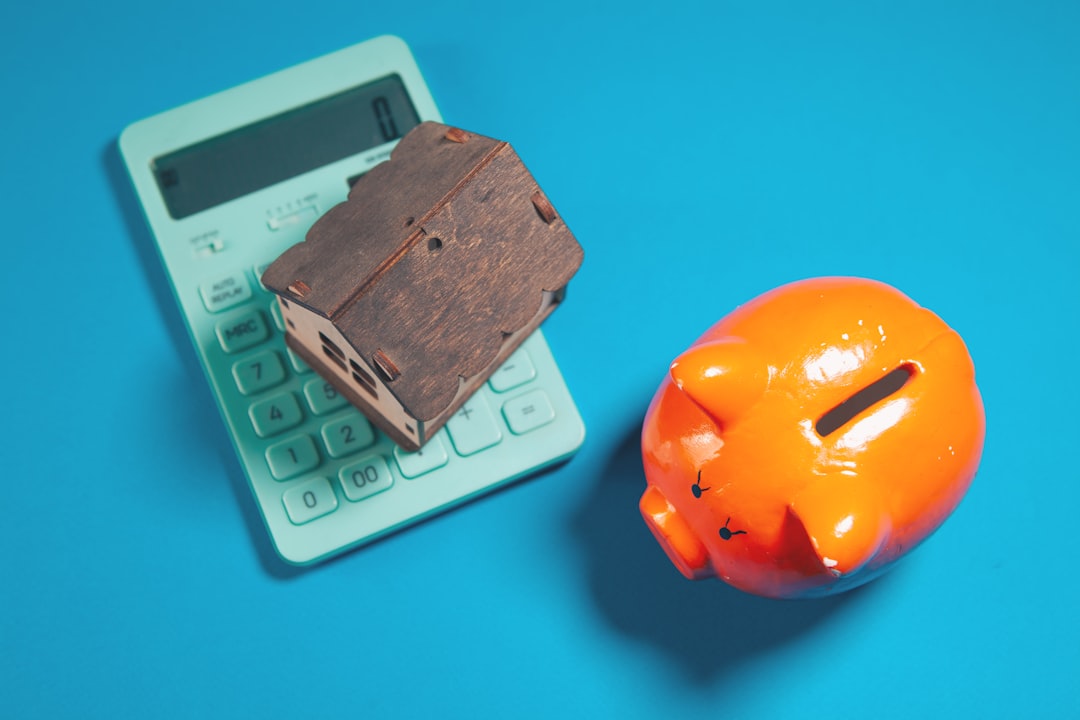piggy bank with calculator and orange background